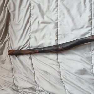 HandmadeMaterials: walking stick with a foot carved on one end.